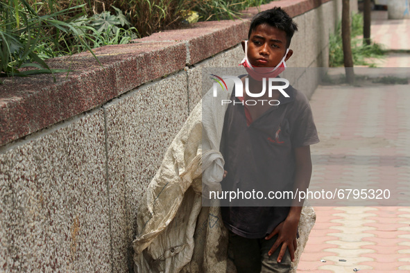 Rahul, 8, a ragpicker looks for recyclable materials specially plastic bottles strewn around roads to support his family, ahead of the World...