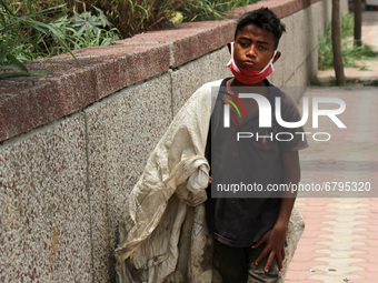 Rahul, 8, a ragpicker looks for recyclable materials specially plastic bottles strewn around roads to support his family, ahead of the World...