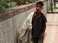 Rahul, 8, a ragpicker looks for recyclable materials specially plastic bottles strewn around roads to support his family, ahead of the World...