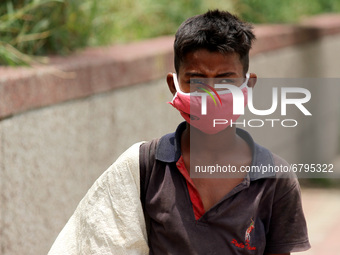 Rahul, 8, a ragpicker looks for recyclable materials specially plastic bottles strewn around roads to support his family, ahead of the World...