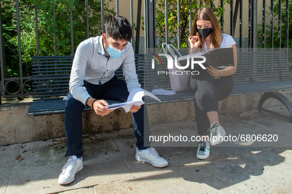 Students last quick review before going in for the oral interview  their exam subjects while waiting for their turn outside the high school...