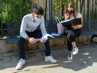 Students last quick review before going in for the oral interview  their exam subjects while waiting for their turn outside the high school...