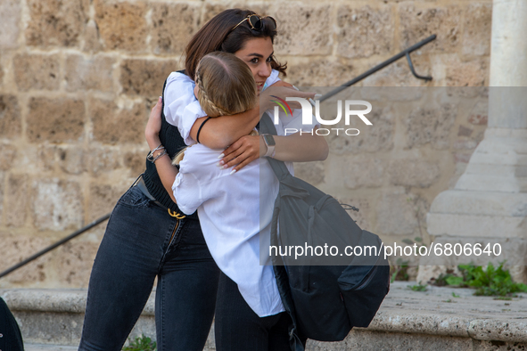 A fifth-year student embraces her friend as she has finished her high-school leaving examination in Rieti, Italy, on June 16, 2021. High-sch...