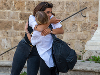 A fifth-year student embraces her friend as she has finished her high-school leaving examination in Rieti, Italy, on June 16, 2021. High-sch...