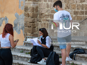 Students last quick review before going in for the oral interview  their exam subjects while waiting for their turn outside the high school...