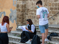 Students last quick review before going in for the oral interview  their exam subjects while waiting for their turn outside the high school...