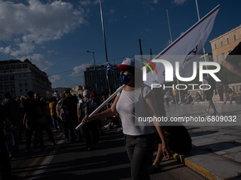  A woman holding a banner during a demonstration in Athens, Greece, on June 16, 2021. Thousands of Athenians gathered outside the parliament...