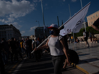  A woman holding a banner during a demonstration in Athens, Greece, on June 16, 2021. Thousands of Athenians gathered outside the parliament...