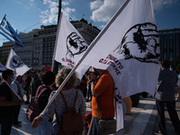  Demonstrators holding flags during a general strike in Athens, Greece, on June 16, 2021. Thousands of Athenians gathered outside the parlia...