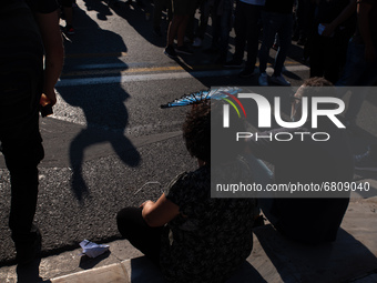  A pensioner with her hand fan in Athens, Greece, on June 16, 2021. Thousands of Athenians gathered outside the parliament to protest agains...