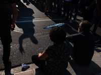  A pensioner with her hand fan in Athens, Greece, on June 16, 2021. Thousands of Athenians gathered outside the parliament to protest agains...