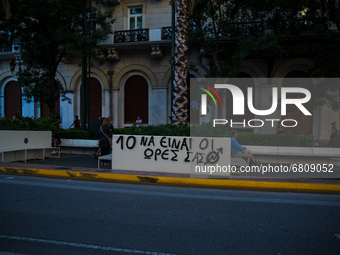  A graffitti against the 10 hour work day scheme that is introduced by the Greek government's new legislation.  (