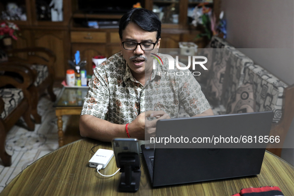 Rajaram Paul Chowdhury teaches an online high school English class from  his home during a government imposed lockdown in Dhaka , Bangladesh...