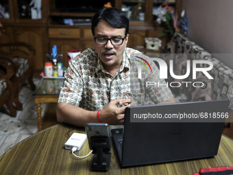 Rajaram Paul Chowdhury teaches an online high school English class from  his home during a government imposed lockdown in Dhaka , Bangladesh...