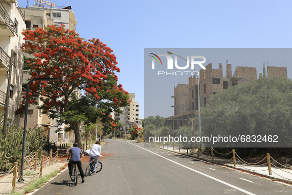 Tourists cycle through an area fenced in by the Turkish military since 1974 in the abandoned coastal area of Varosha, a suburb of the city o...