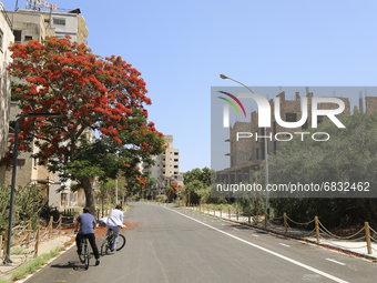 Tourists cycle through an area fenced in by the Turkish military since 1974 in the abandoned coastal area of Varosha, a suburb of the city o...