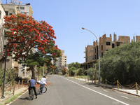 Tourists cycle through an area fenced in by the Turkish military since 1974 in the abandoned coastal area of Varosha, a suburb of the city o...