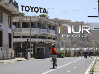 A boy rides a bicycle through an area fenced in by the Turkish military since 1974 in the abandoned coastal area of Varosha, a suburb of the...