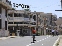 A boy rides a bicycle through an area fenced in by the Turkish military since 1974 in the abandoned coastal area of Varosha, a suburb of the...