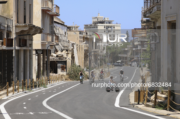 Tourists cycle through an area fenced in by the Turkish military since 1974 in the abandoned coastal area of Varosha, a suburb of the city o...