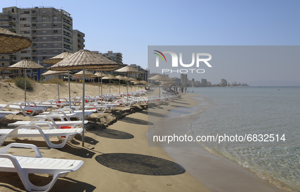 Abandoned buildings in Varosha, an area fenced off by the Turkish military since the 1974 division of Cyprus, are seen from a beach in Famag...