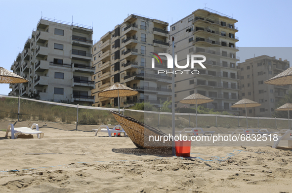 Abandoned buildings in Varosha, an area fenced off by the Turkish military since the 1974 division of Cyprus, are seen from a beach in Famag...