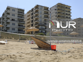 Abandoned buildings in Varosha, an area fenced off by the Turkish military since the 1974 division of Cyprus, are seen from a beach in Famag...