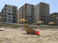 Abandoned buildings in Varosha, an area fenced off by the Turkish military since the 1974 division of Cyprus, are seen from a beach in Famag...