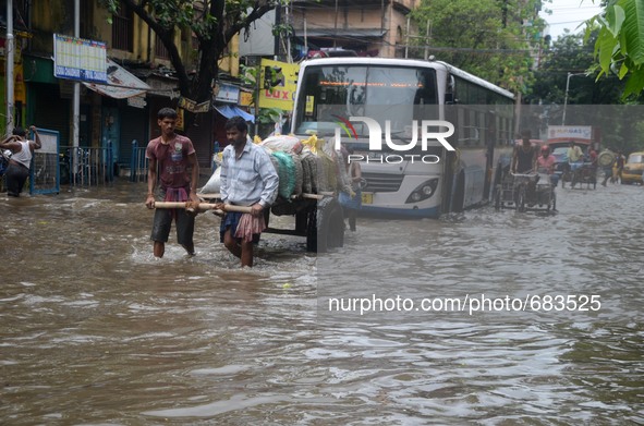 Busy waterlogged street due to heavy rain in Kolkata, India on  Friday, July 10, 2015. 