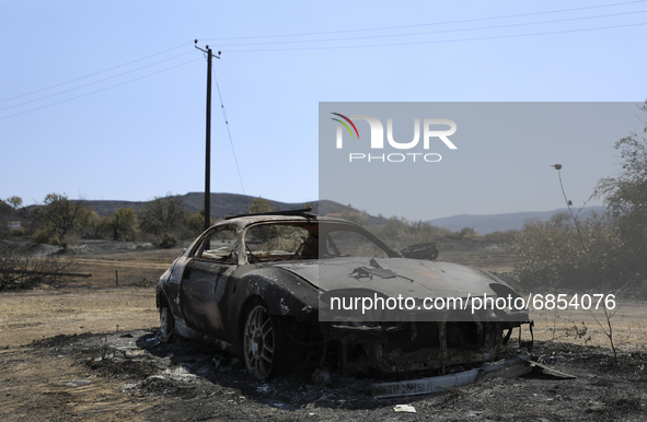 A burned car in the village Eptagonia, in the mountainous area of Limassol. Cyprus, Monday, 5 July, 2021. The wildfires that have been ragin...