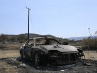 A burned car in the village Eptagonia, in the mountainous area of Limassol. Cyprus, Monday, 5 July, 2021. The wildfires that have been ragin...