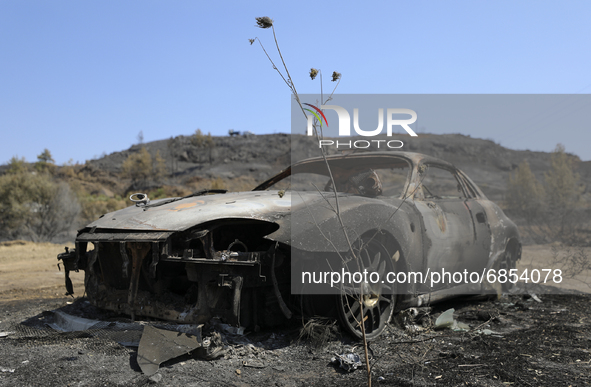 A burned car in the village Eptagonia, in the mountainous area of Limassol. Cyprus, Monday, 5 July, 2021. The wildfires that have been ragin...