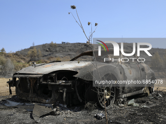 A burned car in the village Eptagonia, in the mountainous area of Limassol. Cyprus, Monday, 5 July, 2021. The wildfires that have been ragin...