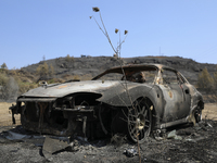 A burned car in the village Eptagonia, in the mountainous area of Limassol. Cyprus, Monday, 5 July, 2021. The wildfires that have been ragin...