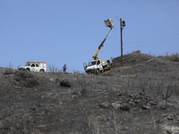 Electricity power engineers at work, in the burned Limassol mountain region near Eptagonia village. Cyprus, Monday, July 5, 2021. The wildfi...