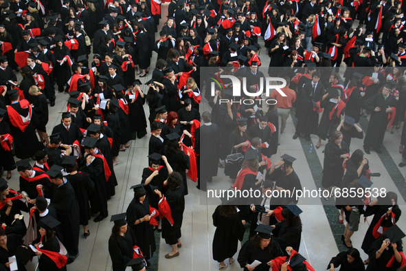 New university graduates line-up in a hall before convocation in Ontario, Canada, on June 16, 2008. 