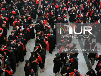 New university graduates line-up in a hall before convocation in Ontario, Canada, on June 16, 2008. (