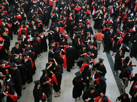 New university graduates line-up in a hall before convocation in Ontario, Canada, on June 16, 2008. (