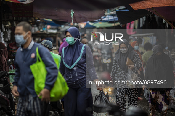 Gloomy faces of sellers and buyers at a traditional market in Pamulang area, South Tangerang, Banten, Indonesia on July 23, 2021. For almost...