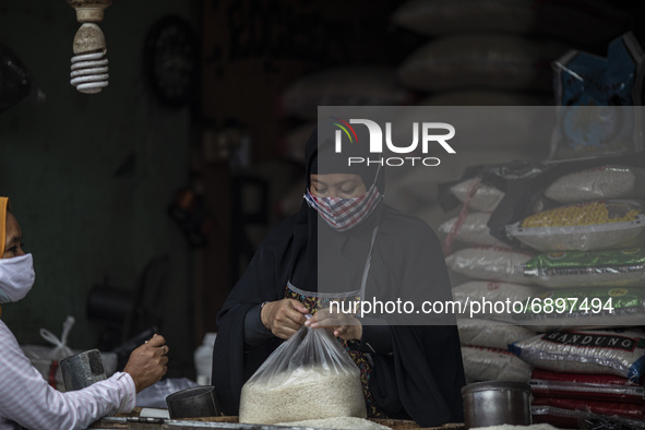 Gloomy faces of sellers and buyers at a traditional market in Pamulang area, South Tangerang, Banten, Indonesia on July 23, 2021. For almost...