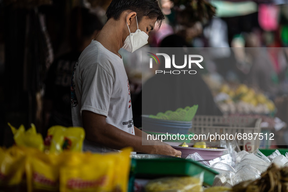 Gloomy faces of sellers and buyers at a traditional market in Pamulang area, South Tangerang, Banten, Indonesia on July 23, 2021. For almost...