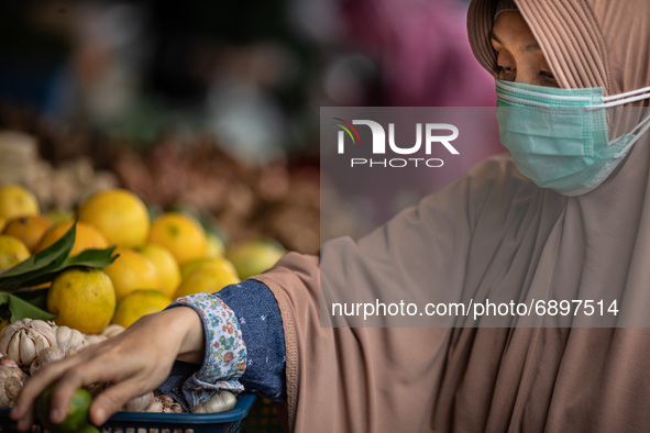 Gloomy faces of sellers and buyers at a traditional market in Pamulang area, South Tangerang, Banten, Indonesia on July 23, 2021. For almost...