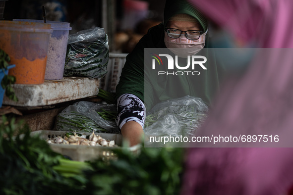 Gloomy faces of sellers and buyers at a traditional market in Pamulang area, South Tangerang, Banten, Indonesia on July 23, 2021. For almost...