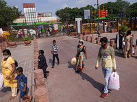 People visit recently developed pedestrian corridor while shipping containers are placed in front of the Red Fort ahead of India's 75th Inde...