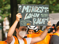 a protester holds a sign of " wage up"  is seen during the riders from Lieferando protest for better working condition in Cologne, Germanz o...