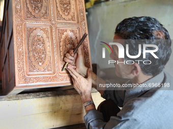 Kashmiri craftsman polishes a hand carved walnut drawer in a small floating workshop on Dal Lake in Srinagar, Kashmir, India, on June 26, 20...