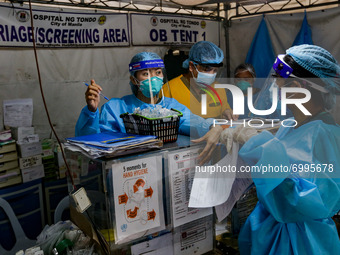 Health workers man the triage area of a hospital placed along a main road in Manila City, Philippines on August 26, 2021. At least two more...