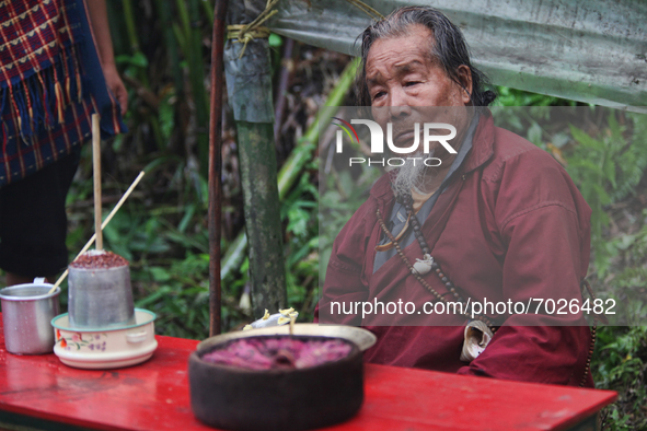 A 90 year-old Lepcha Bomthing (Lepcha priest) chants prayers during an animal sacrifice ceremony to appease evil spirits in a small village...
