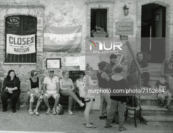 Mimmo Lucano, former mayor of Riace (on the right, sitting on the stairs) is pictured in this photograph during the days of his hunger strik...