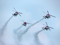 Indian Air Force's Sarang helicopters perform during the full dress rehearsal of Air Force Day parade at the Hindon Air Force Station on the...